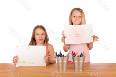 Young girls show their drawings Young girls show their drawings