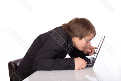 Sleepy business man look closely his laptop Sleepy business man look closely his laptop