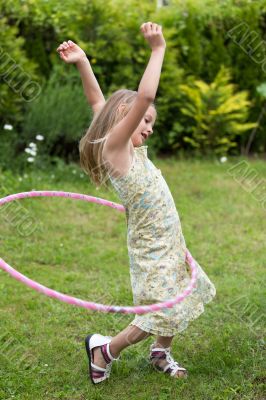 Little girl playing with hula hoop