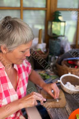 Senior woman cutting food Senior woman cutting food