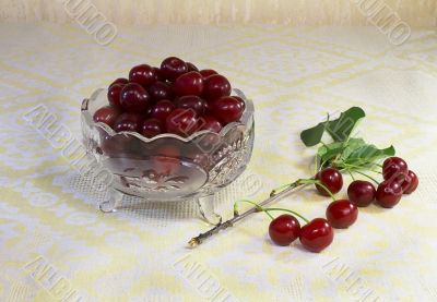 Cherries in a crystal vase on the table