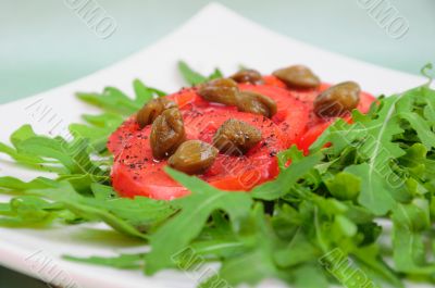 Salad with fresh tomatoes, capers and arugula