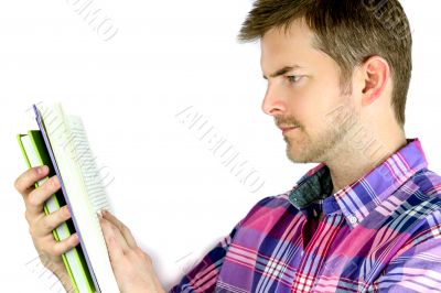 Thoughtful young man reading a book