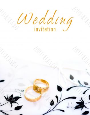 Golden rings on a wedding invitation