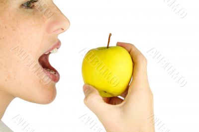 Girl taking a bite of an apple.