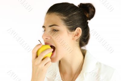 Girl taking a bite of an apple.