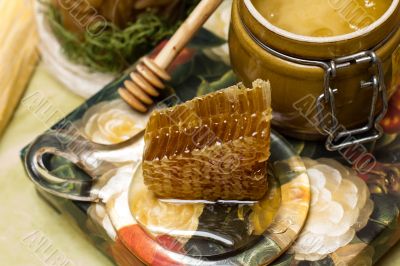 Honey in pot, honeycomb and stick