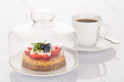 Cheesecake, glass bell and cup of coffee