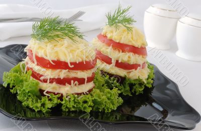 Appetizer of tomato slices with a sharp cheese filling