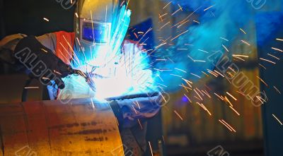 worker with protective mask welding metal 