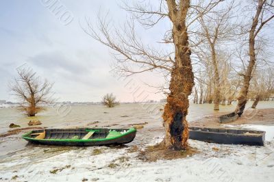 green boat on shore in winter