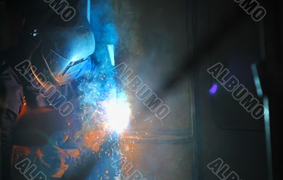 Industrial worker welding in factory