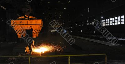 worker using torch cutter to cut through metal