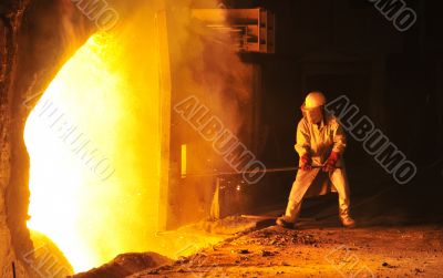 worker takes a sample at steel company 