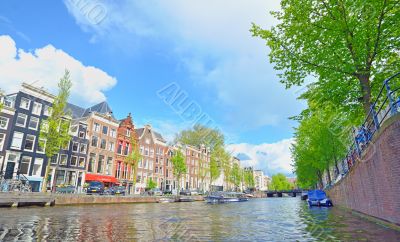 Traditional Houses and house boat along canal in Amsterdam