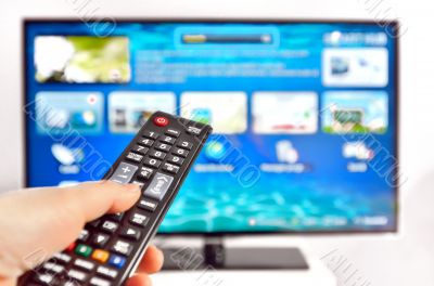 Smart tv and  hand pressing remote control