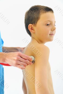 boy having health check with stethoscope in hospital 