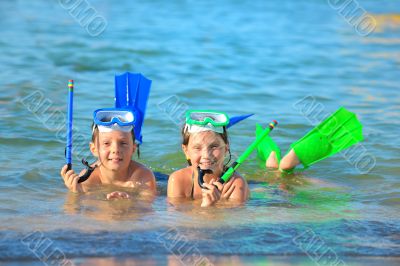 children on beach with snorkles children on beach with snorkles