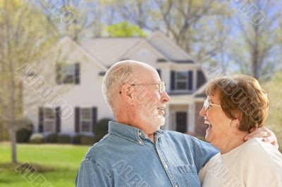 Happy Senior Couple in Front Yard of House Happy Senior Couple in Front Yard of House