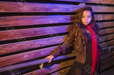 Mixed Race Young Adult Woman Against a Wood Wall Background