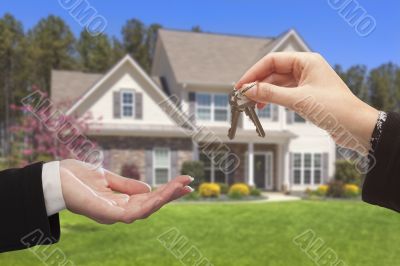Agent Handing Over the House Keys in Front of New Home Agent Handing Over the House Keys in Front of New Home