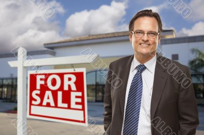 Businessman In Front of Office Building and For Sale Sign