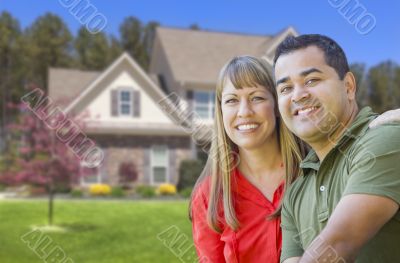 Happy Mixed Race Couple in Front of House