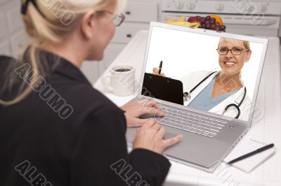 Woman In Kitchen Using Laptop - Online with Nurse or Doctor