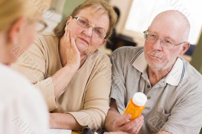 Doctor or Nurse Explaining Prescription Medicine to Senior Coupl