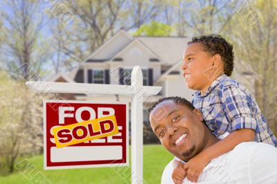 Mixed Race Father and Son In Front of Real Estate Sign and House Mixed Race Father and Son In Front of Real Estate Sign and House