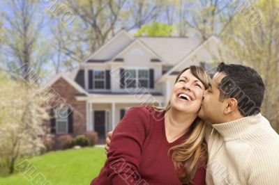 Happy Mixed Race Couple in Front of House