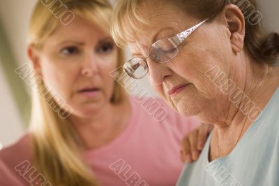 Young Woman Consoles Senior Adult Female