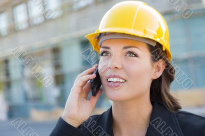 Young Female Contractor Wearing Hard Hat on Site Using Phone