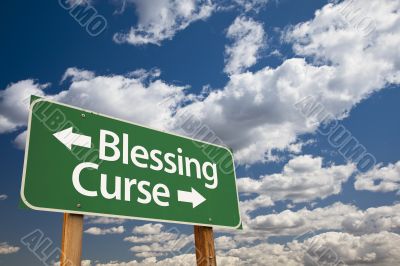Blessing, Curse Green Road Sign and Clouds Blessing, Curse Green Road Sign and Clouds