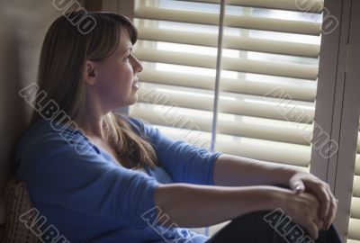 Pensive Woman Sitting Near Window Shades Pensive Woman Sitting Near Window Shades