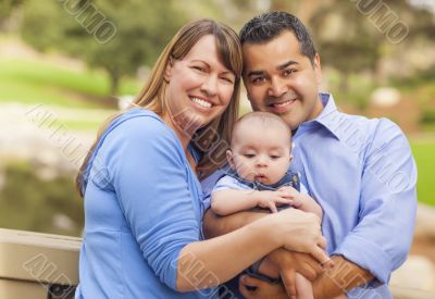 Happy Mixed Race Family Posing for A Portrait Outside