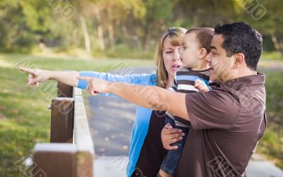 Happy Mixed Race Family Playing In The Park