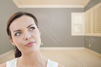 Young Woman Daydreaming in Empty Grey Room