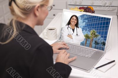 Woman In Kitchen Using Laptop - Online with Nurse or Doctor