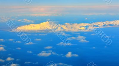 aerial view of mountains and clouds on top