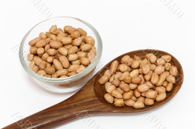 peanuts and spoon isolated on white background