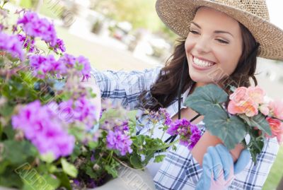 Young Adult Woman Wearing Hat Gardening Outdoors