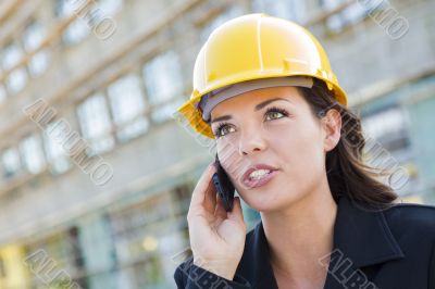 Young Female Contractor Wearing Hard Hat on Site Using Phone