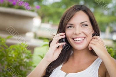 Young Adult Female Talking on Cell Phone Outdoors on Bench