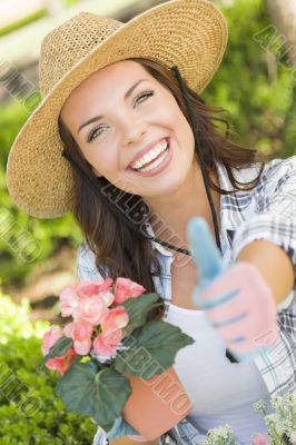 Young Adult Woman Wearing Hat Gardening Outdoors