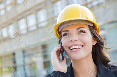 Young Female Contractor Wearing Hard Hat on Site Using Phone Young Female Contractor Wearing Hard Hat on Site Using Phone