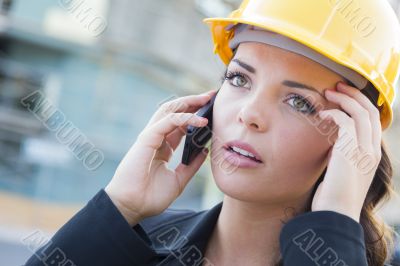 Worried Female Contractor Wearing Hard Hat on Site Using Phone Worried Female Contractor Wearing Hard Hat on Site Using Phone