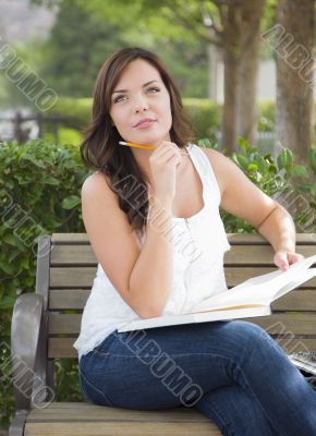 Young Adult Female Student on Bench Outdoors