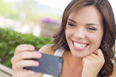 Young Adult Female Texting on Cell Phone Outdoors