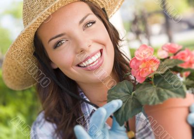 Young Adult Woman Wearing Hat Gardening Outdoors